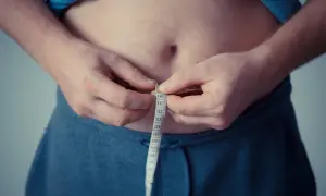 Osoba mierzy obwód talii, co może wskazywać na zaburzenia metabolizmu lipoprotein i inne lipidemie.