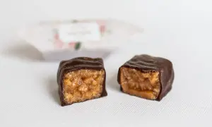 Dwie połówki czekoladowej krówki, ukazujące jej karmelowe wnętrze. Idealna na małą przekąskę, gdy liczymy krówkę kcal.