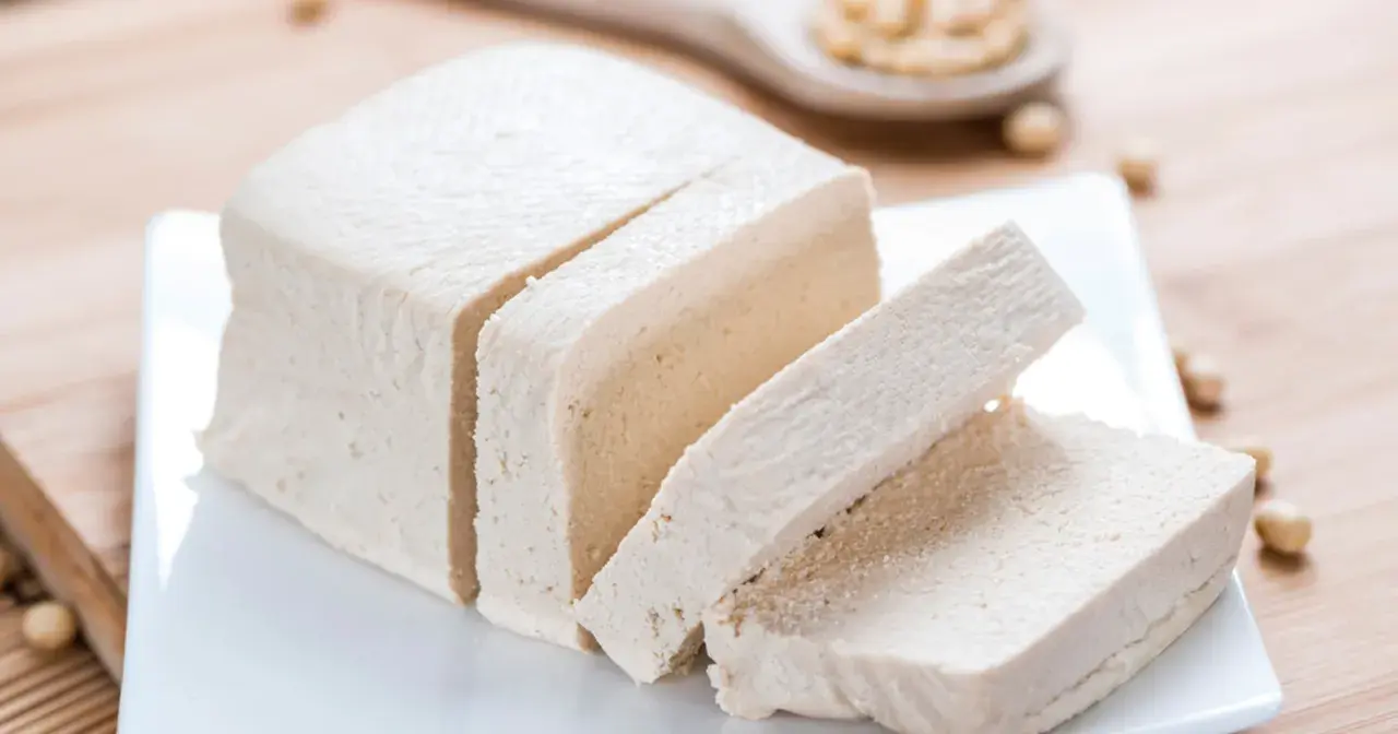 Kawałek pokrojonego tofu na talerzyku. Czy tofu jest zdrowe? To pytanie zadaje sobie wiele osób, szukając zdrowych alternatyw.