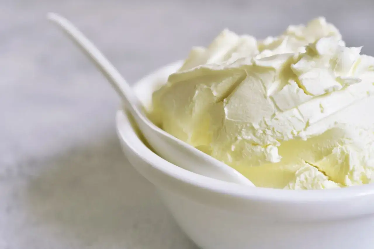 Kremowy serek mascarpone w białej miseczce, gotowy do deseru. Warto sprawdzić mascarpone kcal przed dodaniem do tiramisu.
